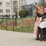 Spinal cord injury lawyer (Mother and daughter share a warm embrace in a park, highlighting love and mobility support.)