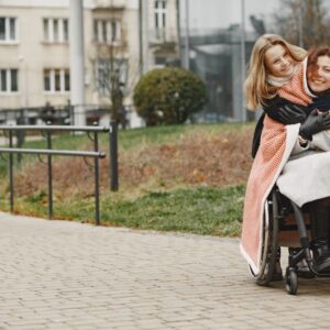 Spinal cord injury lawyer (Mother and daughter share a warm embrace in a park, highlighting love and mobility support.)