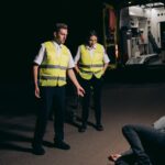 Pedestrian accident lawyer (Paramedics assist a patient on a dimly lit street, showcasing emergency response at night.)