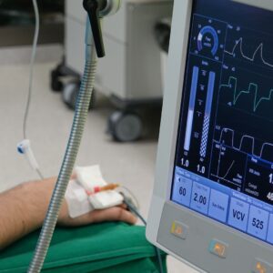 Workplace injury statistics 2026 (A close-up of a patient's hand connected to medical equipment in an ICU room.)