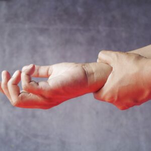 Repetitive stress injury workers comp (Close-up of hands, one grasping the other, symbolizing pain or discomfort.)