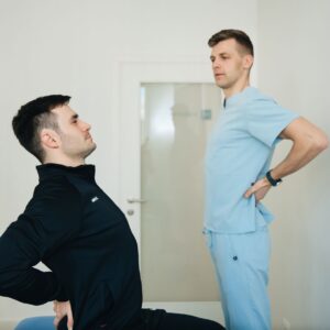Average workers comp settlement back injury (A physiotherapist instructs a patient on back exercises in a clinic setting.)