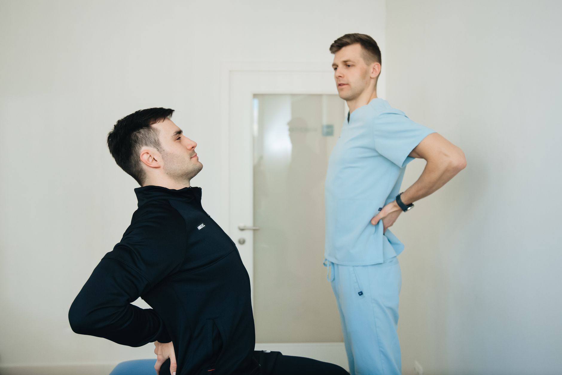 Average workers comp settlement back injury (A physiotherapist instructs a patient on back exercises in a clinic setting.)