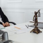 Personal injury law firm (A legal professional's workspace featuring Lady Justice statue, documents, and a laptop.)