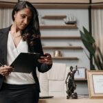 Best personal injury lawyer (Confident businesswoman reviewing paperwork in a modern law office setting.)
