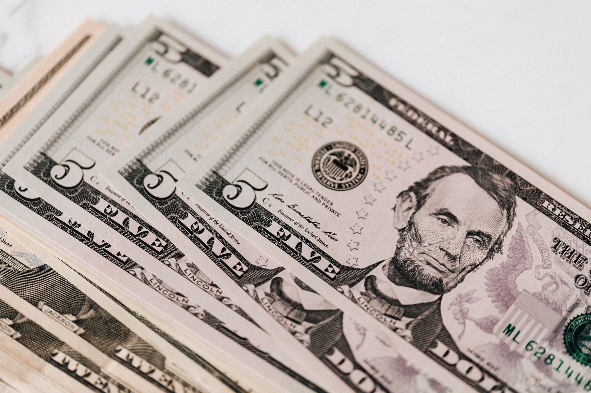 Whiplash settlement amount (Top view of stack of US dollar banknotes placed together on white background)