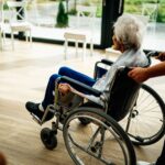 Nursing home abuse lawyer (A caregiver assists a senior adult in a wheelchair at a nursing home in Prague, Czech Republic.)