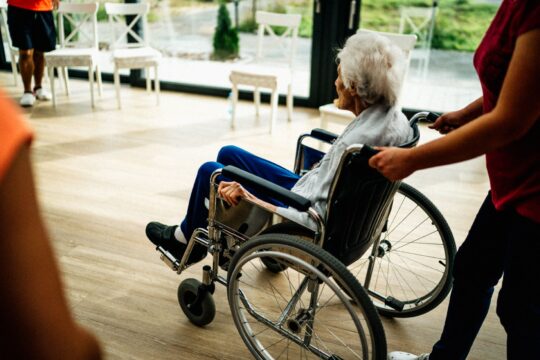 Nursing home abuse lawyer (A caregiver assists a senior adult in a wheelchair at a nursing home in Prague, Czech Republic.)