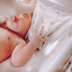 Birth injury lawyer (A newborn baby in a hospital setting receiving care with a focus on wellness and health.)