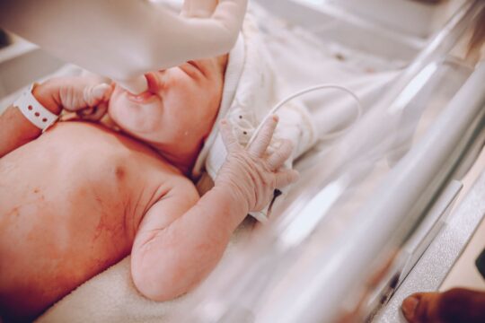 Birth injury lawyer (A newborn baby in a hospital setting receiving care with a focus on wellness and health.)